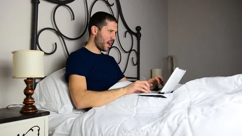 Caucasian businessman typing on tablet while on bed in a luxury suite 스톡 동영상 122306418