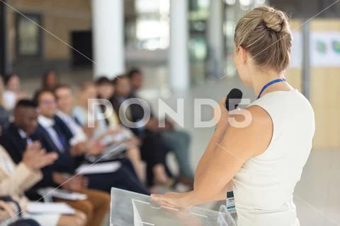 Caucasian businesswoman doing a speech in conference room Stock Photos