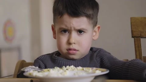 Caucasian child does not want to eat porridge. Crying boy. Food concept. Healthy Stock Footage 201952000