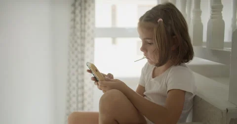 Caucasian child hangs on the phone while parents work at home. Stock Footage 245690701