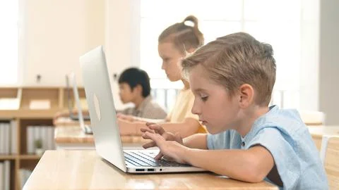 Caucasian child programing software system and learning about coding. Pedagogy. Stock Photos