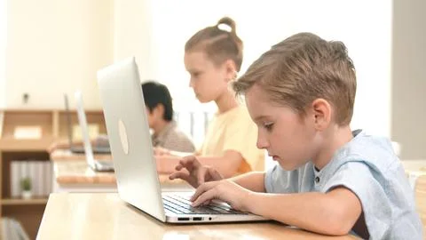 Caucasian child programing software system and learning about coding. Pedagogy. Stock Photos