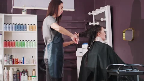 Caucasian client receives precise trim in contemporary beauty space Stock Footage 323121664