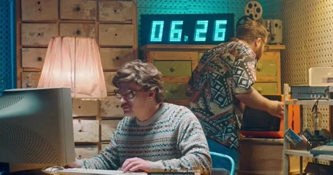 Caucasian computer programist nerd in glasses working at vintage PC monitor and Stock-Footage 135630207