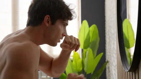 Caucasian confident man looking reflection in bathroom mirror pointing Stock Footage 253285882