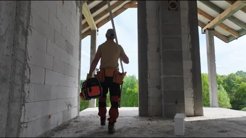 Caucasian Construction Worker Walking Through Unfinished House Stock Footage 275270982