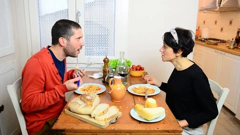Caucasian couple discuss while have lunch together in the kitchen 스톡 동영상 122297305