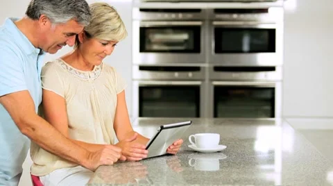 Caucasian Couple in Home Kitchen Using Wireless Tablet  Stock Footage 8752329
