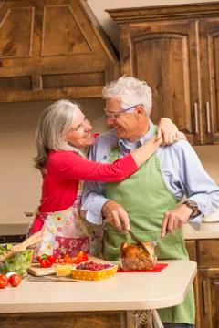 Caucasian couple hugging in kitchen Stock Photos
