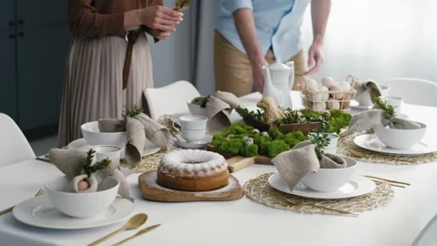 Caucasian couple preparing  table for easter dinner Stock Footage 170835054