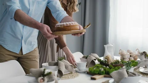 Caucasian couple preparing  table for easter dinner Stock Footage 170876447