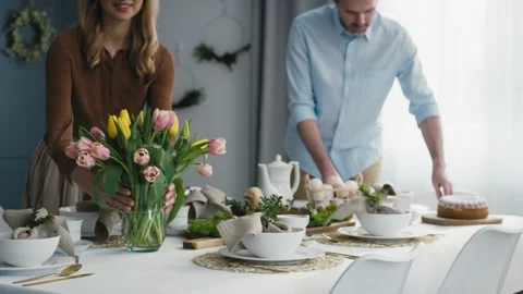 Caucasian couple preparing  table for easter dinner Video stock 170876546
