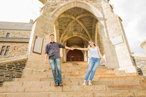 Caucasian couple standing on castle steps Fotos de archivo
