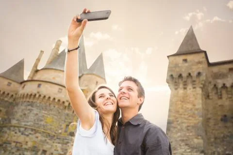 Caucasian couple taking selfie at castle Fotos de archivo