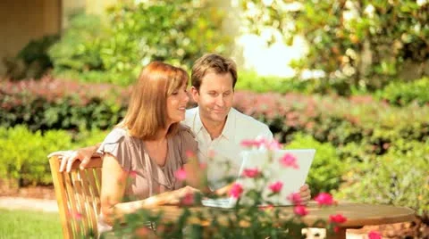 Caucasian Couple Using Computer Garden Stock Footage