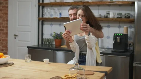 Caucasian couple won a computer game on tablet Stock Footage 104607889