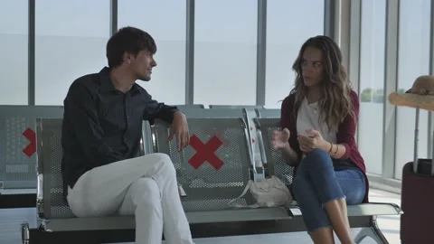 Caucasian couples sit on the chair using a smartphone in the lounge. Stock Footage 138511071