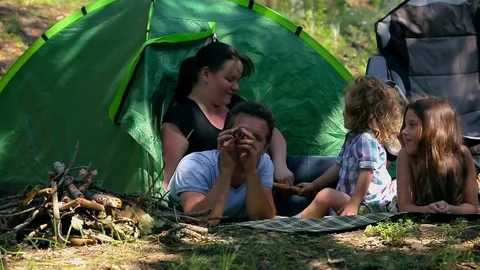 Caucasian dad and son assembling tent on holiday outdoors Stock Footage 74670107