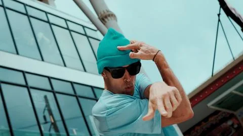 Caucasian dancer looking at camera while dancing at sky scrapper. Endeavor. Stock Photos