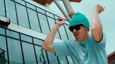 Caucasian dancer looking at camera while dancing at sky scrapper. Hiphop. Stock Photos