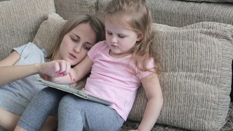 Caucasian daughter using tablet Stock Footage 71343089