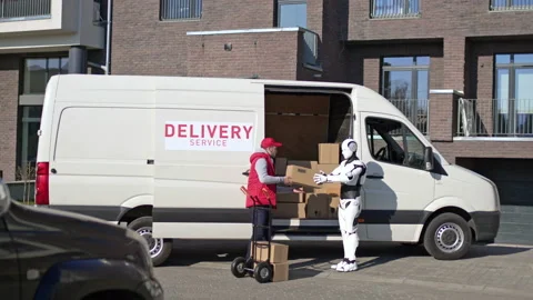 Caucasian delivery man with robot put parcel boxes from a van on a trolley Stock Footage 166174997