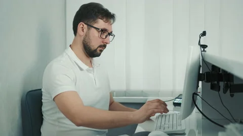 Caucasian dentist sitting at the computer at the reception and recording the Stock Footage 150900402