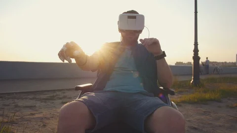 Caucasian desability man in wheelchair using virtual reality headset at sunny Stock Footage 110218957