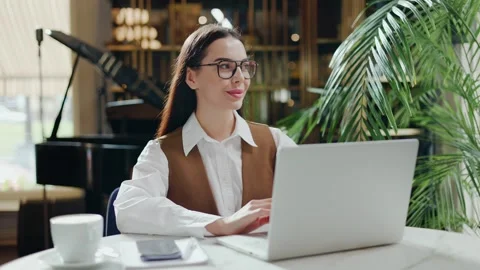 Caucasian developer in cafe, freelancer coding indoors, girl in restaurant. Stock Footage 254467552