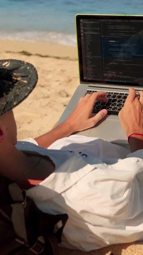 Caucasian Developer Coding on Laptop While Lying on Sandy Beach Stock Footage 336649072