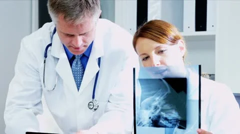 Caucasian Doctor Checking X- Ray Film using tablet  Vídeos de archivo 12139828