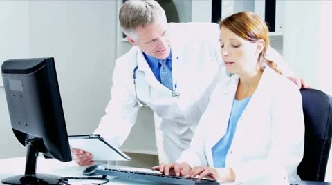 Caucasian Doctors Using Clinical Computer Data  Stock Footage 12139812