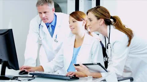 Caucasian Doctors Using Clinical computer Data  Stock Footage 12141154