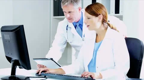 Caucasian Doctors Using Clinical Technology Data  Stock Footage 12140078