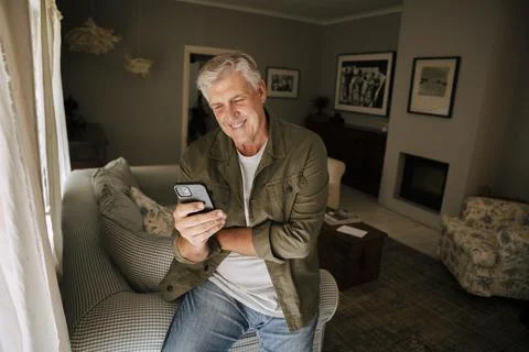 Caucasian elderly man texting on cellular device Stock Photos