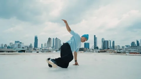 Caucasian energetic B-boy dancer practicing street dancing at rooftop. hiphop. Stock Footage 264079463