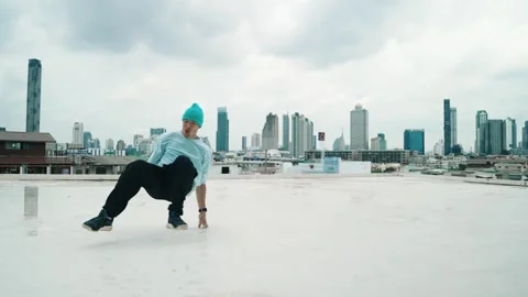 Caucasian energetic B-boy dancer practicing street dancing at rooftop. hiphop. Stock Footage 273555148