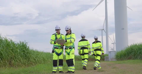 Caucasian engineer colleagues wearing reflective safety uniform using tablet to Stock Footage 337165388