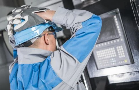 Caucasian Engineer Made Mistake While Programming CNC Machine. Foto stock