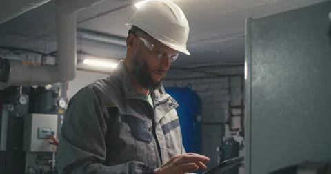 Caucasian engineer uses digital tablet to check energy system 写真素材