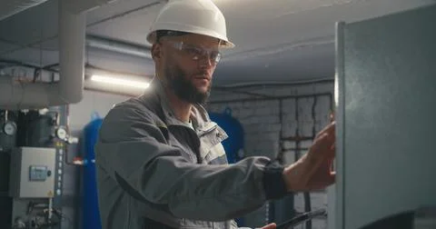 Caucasian engineer uses digital tablet to check energy system 写真素材