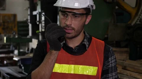 Caucasian engineer using walkie-talkie to communicate while working Stock Footage 147975294