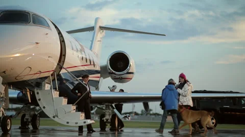 Caucasian family greeting pilot and boarding private jet Stock Footage 191341546