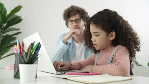 Caucasian father help student doing homework about engineering code. Pedagogy. Stock Footage 269059607