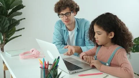 Caucasian father help student doing homework about engineering code. Pedagogy. Photos