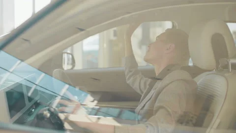 Caucasian female customer testing auto before making purchase. Lady examining Stock Footage 178825001