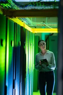 Caucasian female engineer using digital tablet while inspecting in computer Stock Photos