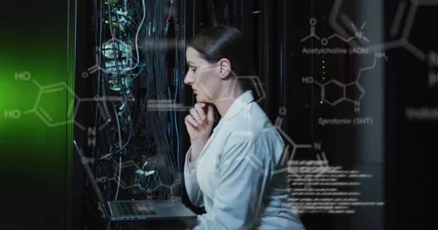 A caucasian female it technician is using a laptop to check a computer server Stock Footage 329033445