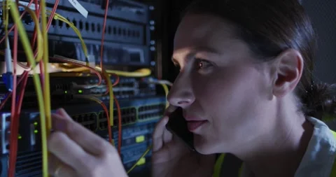 Caucasian female it technician using smartphone checking computer server Stock Footage 336956967
