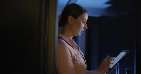 Caucasian female it technician using tablet checking computer server Video stock 338058861